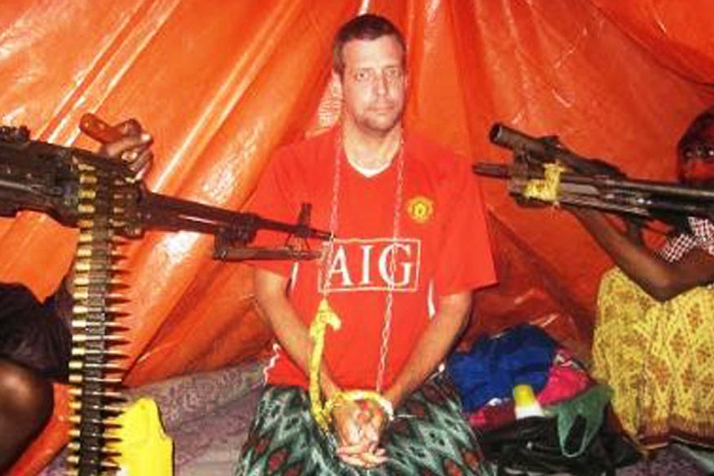Pirates point guns at abductee Moore. Photo: SCMP Pictures
