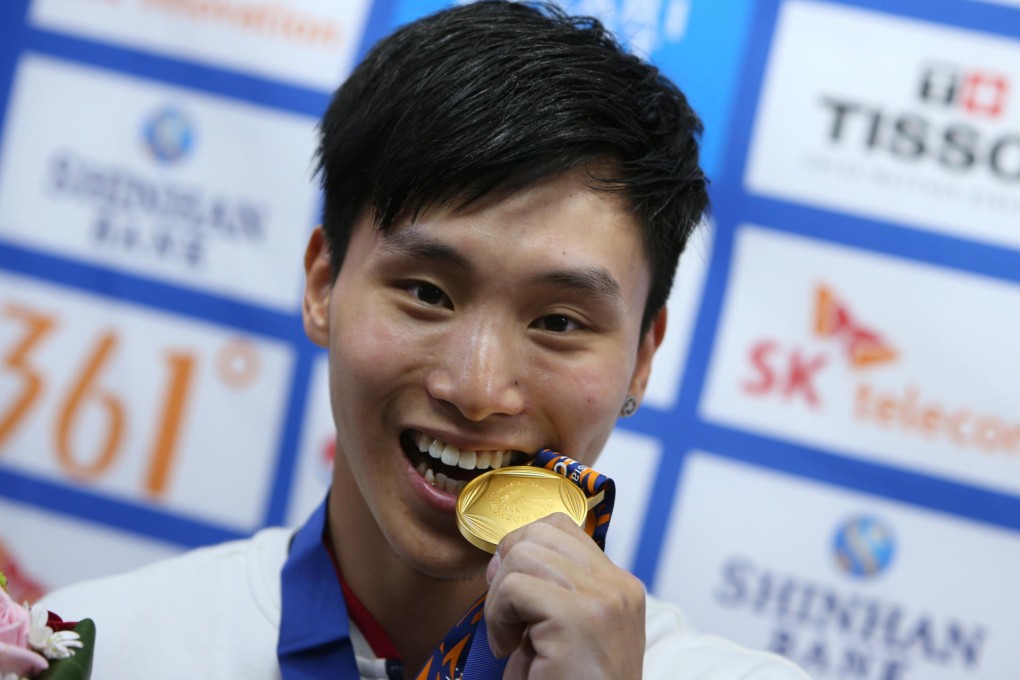 Shek Wai-hung, 22, is pleased as punch over his gold medal - a Hong Kong gymnastics first. Photo: Nora Tam