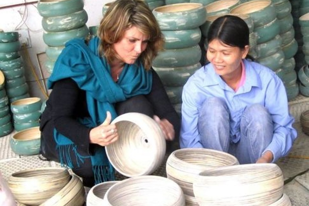 Julia Washbourne with lacquer bowls made by Vietnamese craftspeople.
