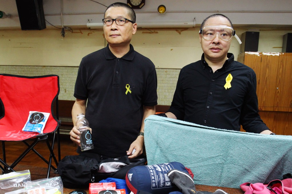 Chan Kin-man (left) and Benny Tai Yiu-ting (right) show off 'goggles, biscuits and towels'. Photo: Dickson Lee