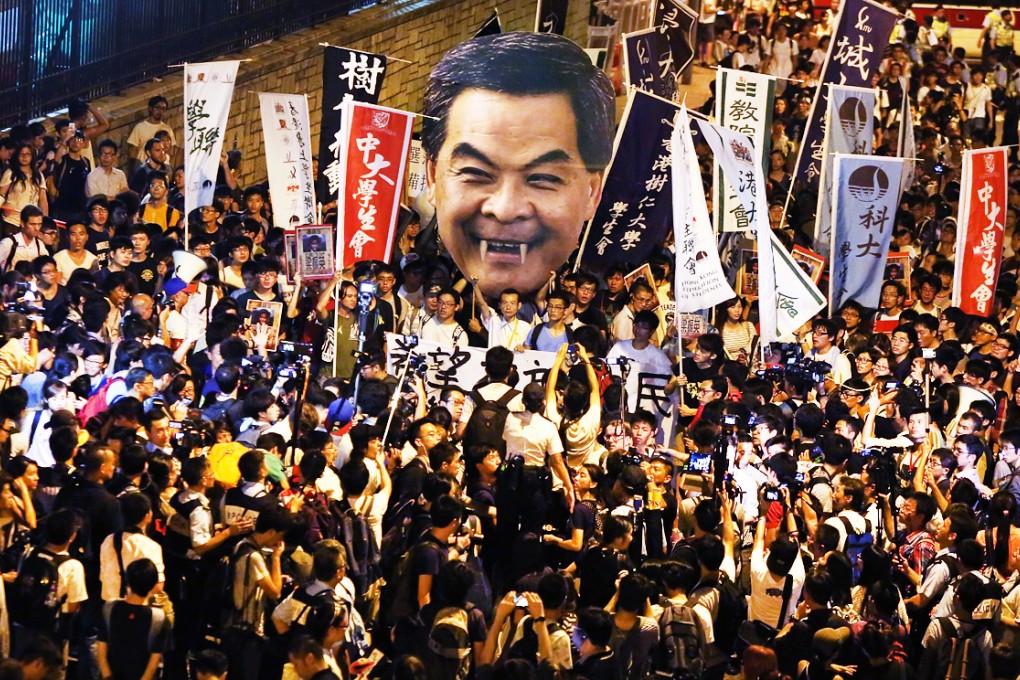 Student protesters carry a giant picture of CY Leung depicted as a vampire. Photo: Sam Tsang