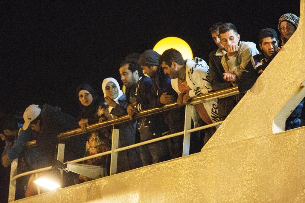 Rescued refugees on the deck of the cruise liner. Photo: AFP