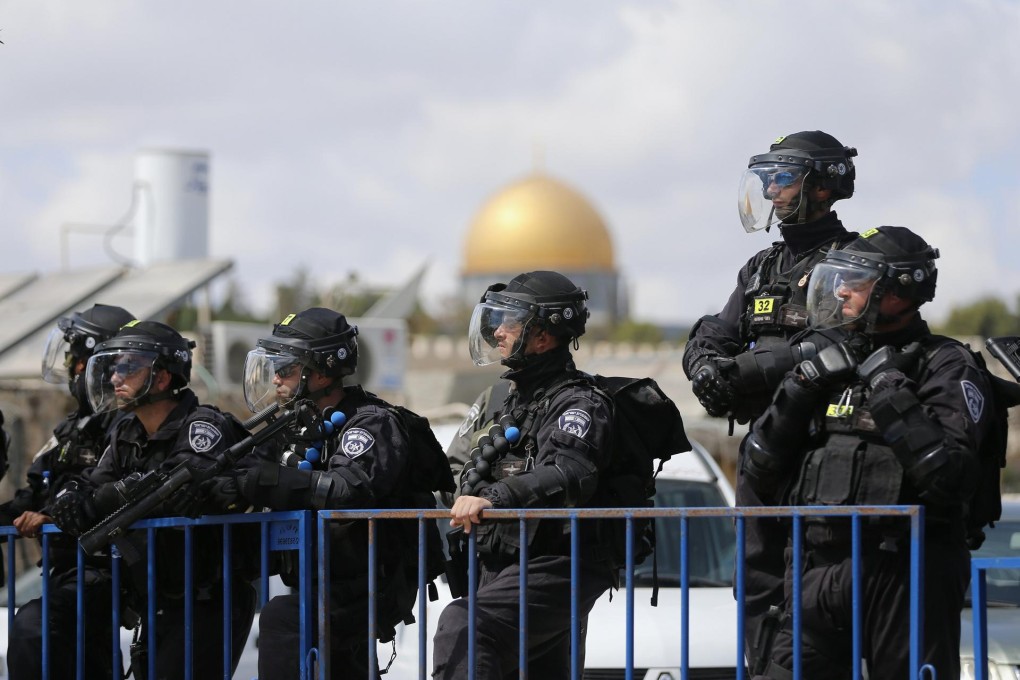 The Dome of the Rock mosque is seen in the background as Israeli police stand guard in East Jerusalem. Photo: Reuters