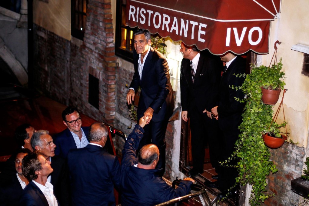 George Clooney (top left) and friends leave a Venice restaurant yesterday. Photo: AFP