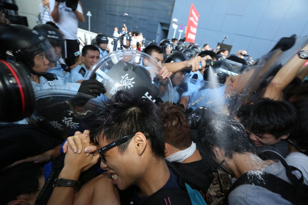 Riot police bring out the pepper spray in Tamar yesterday. Photo: Felix Wong