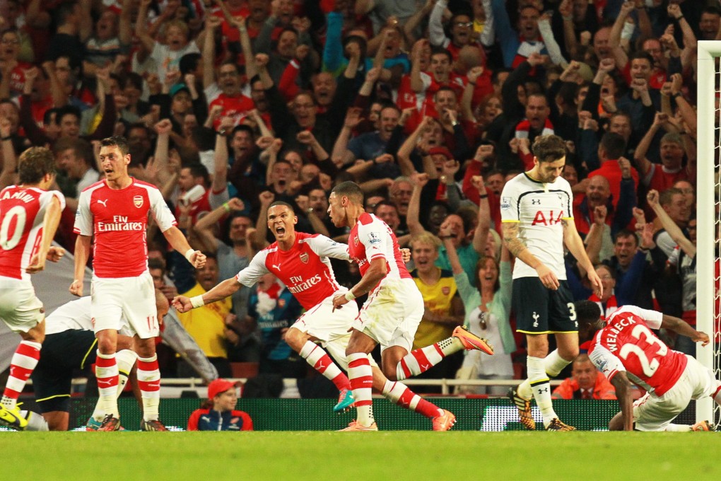 Arsenal's Alex Oxlade-Chamberlain (rear centre) celebrates scoring the equaliser against Tottenham. Photo: EPA