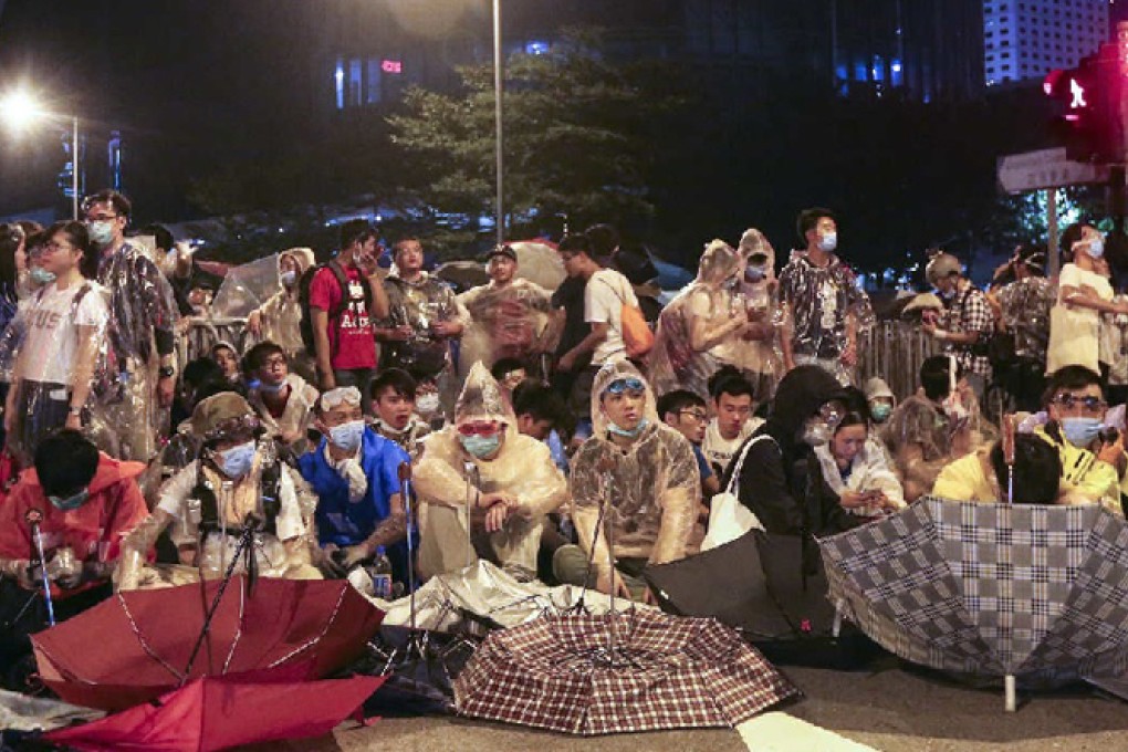 Protesters gather outside the government headquarters, some of them wearing goggles to protect against pepper spray. Well-wishers arrived throughout the day with supplies. Photo: Felix Wong