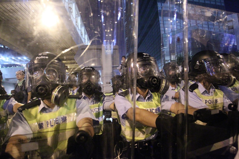 Riot officers stand guard on Connaught Road Central. Photo: Dickson Lee