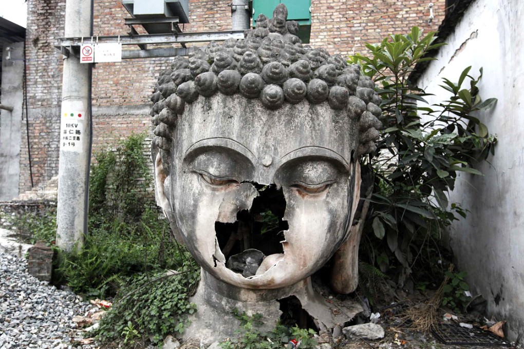 A damaged Buddha statue after last year's quake in Lushan county in Sichuan, one the provinces most at risk of tremors. Photo: Reuters