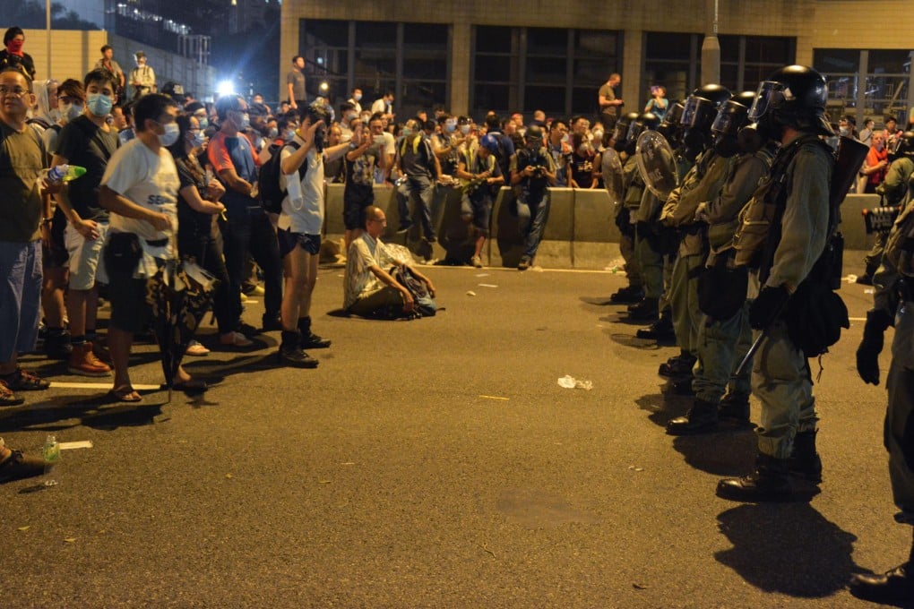 Pro-democracy protesters in Hong Kong face off against police officers in the evening of September 28, 2014. Photo: Kyodo
