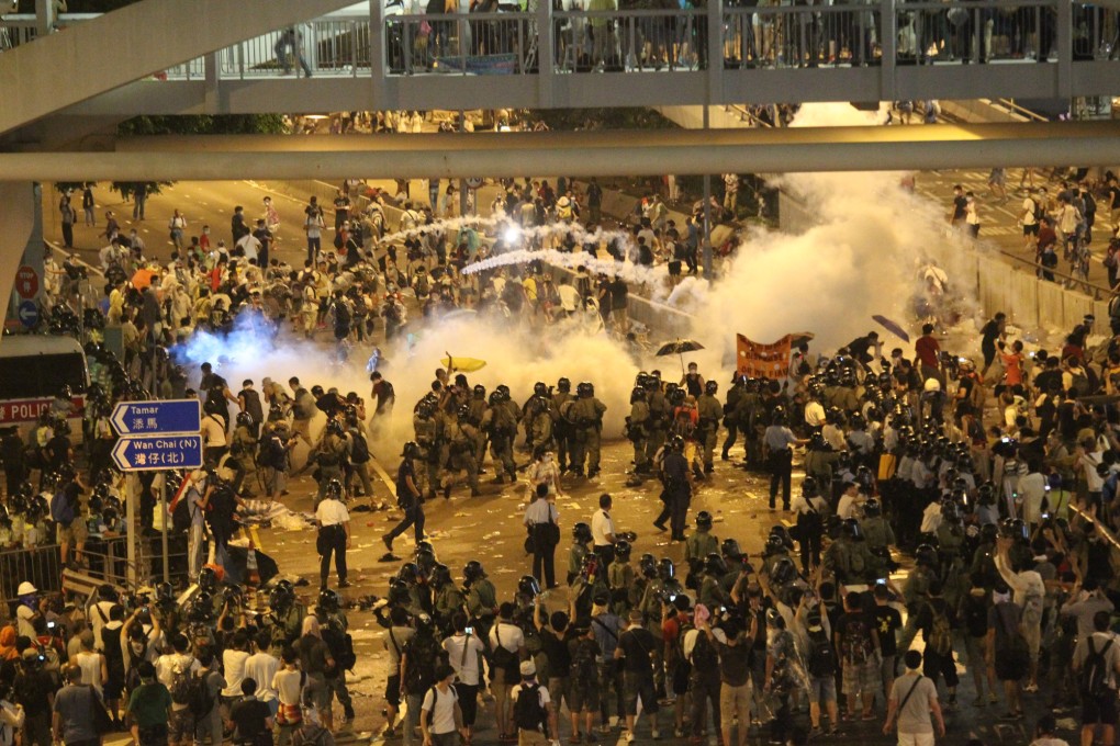 Police fire tear gas at large crowds of protesters near Admiralty on Sunday night. Photo: Sam Tsang