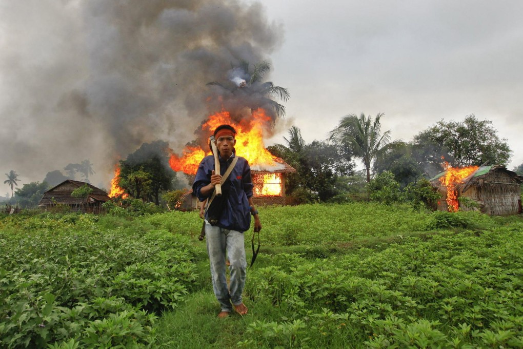 Houses burn in Rakhine state after clashes in 2012. Photo: Reuters