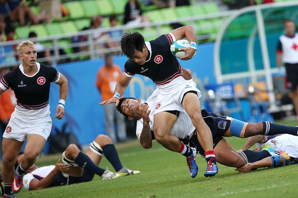 Hong Kong's Salom Yiu Kam-shing fends off a Philippines tackler in their pool game at the Namdong Asiad Rugby Field in Incheon. Photos: Nora Tam/SCMP