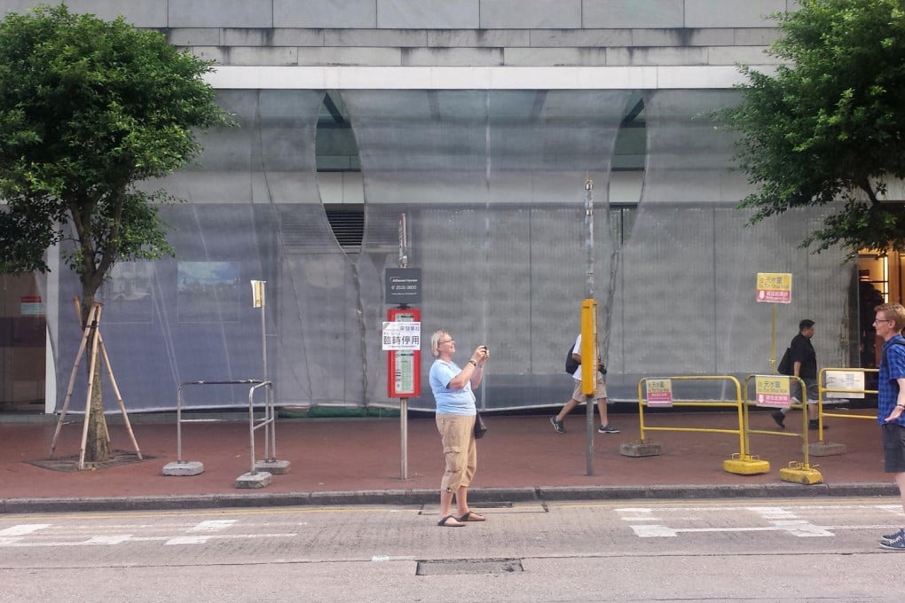 People pose for photos on an empty Queensway, which is blocked to traffic. Photo: Tiffany Ap