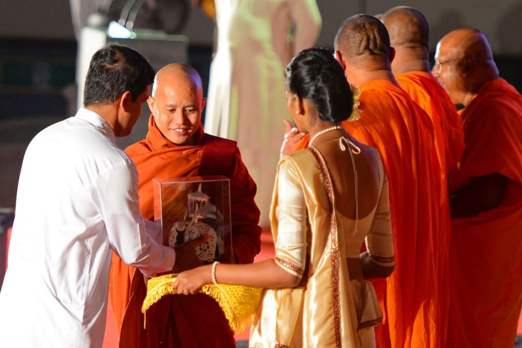 Myanmar monk Ashin Wirathu (Second left) is presented a souvenir during the Bodu Bala Sena (BBS) or Buddhist Force convention in Colombo. Photo: AFP