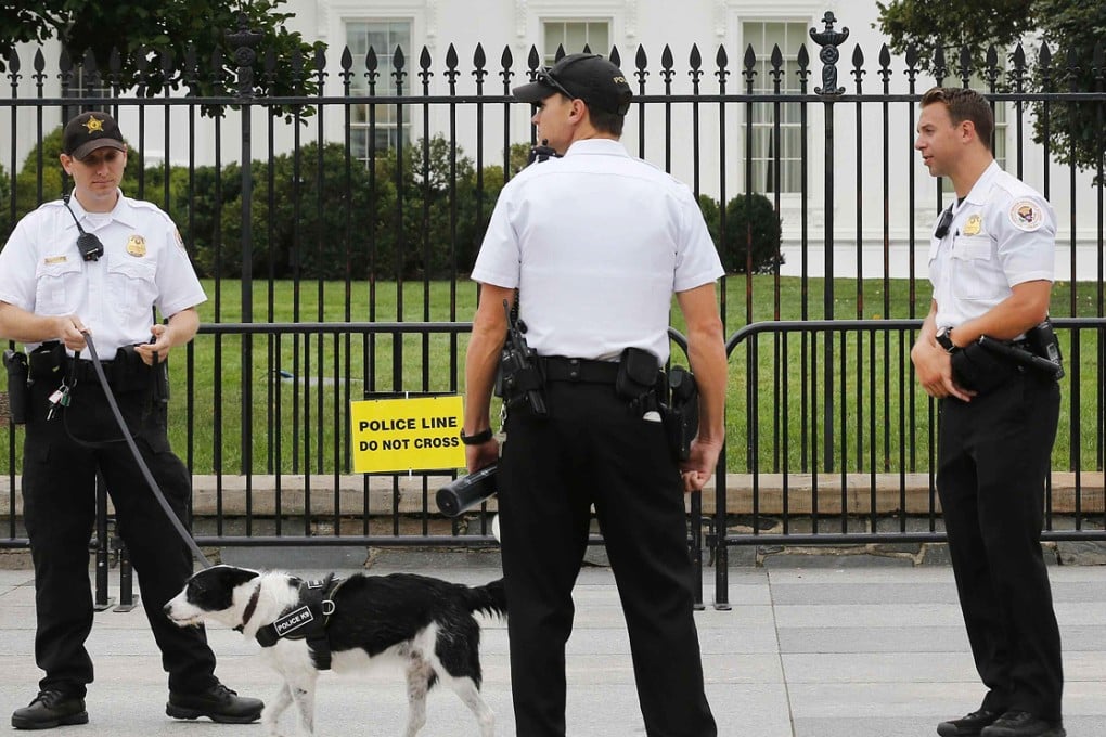 US Secret Service Uniformed Division officers stand along the sidewalk on Pennsylvania Avenue. Photo: Reuters