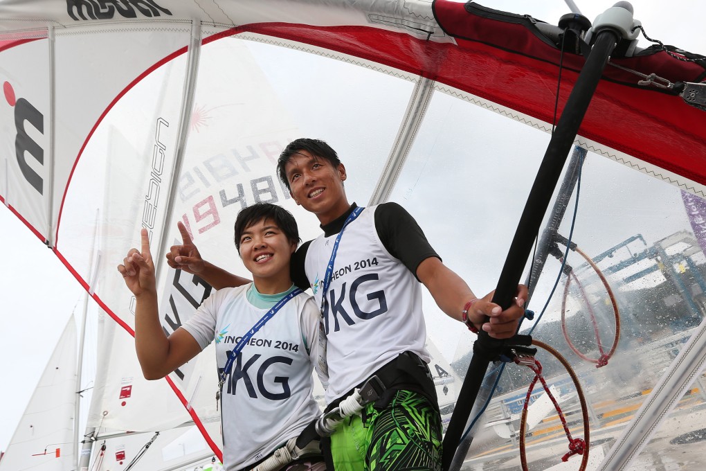 Hong Kong windsurfers Hayley Chan Hei-man and Cheng Kwok-fai show they are "number one" to the media after winning the women's RS:X and the men's mistral. Photo: Nora Tam