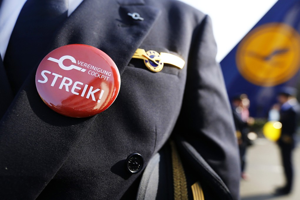 A German airline Lufthansa pilot sporting a button reading "strike" on his uniform. Photo: Reuters