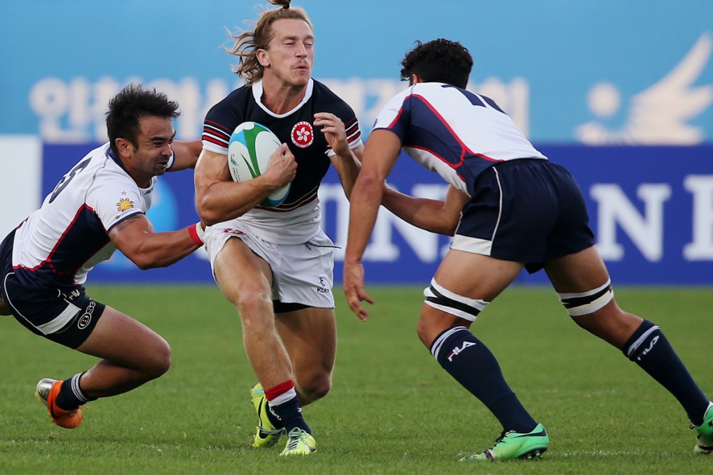 Two-try scorer Tom McQueen braces for impact during Hong Kong’s 21-0 quarter-final win against the Philippines on Wednesday. Photos: Nora Tam/SCMP