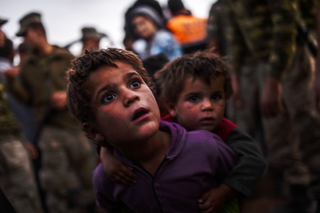 Syrian Kurdish children at the border between Syria and Turkey. Photo: AFP