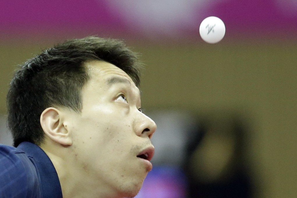 Hong Kong's Jiang Tianyi keeps his eye on the ball as he serves. Photo: AP