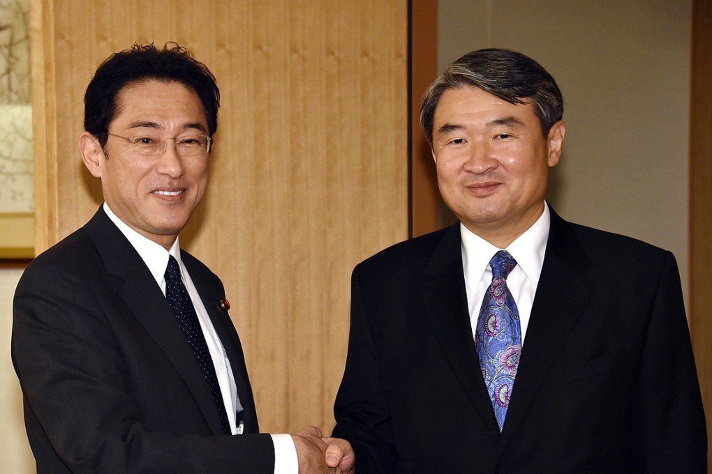 Japanese Foreign Minister Fumio Kishida (left) shakes hands with South Korean First Vice-Foreign Minister Cho Tae-Yong  prior to their talks in Tokyo on Thursday. Photo: AFP