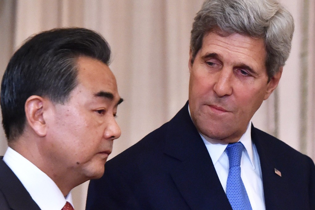 US Secretary of State John Kerry speaks alongside Chinese Foreign Minister Wang Yi (left) in Washington, D.C. on October 1, 2014. Photo: AFP