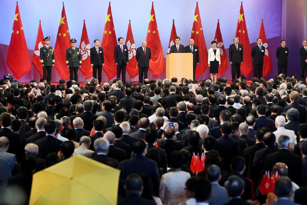 Leung Chun-ying at the ceremony, and Paul Zimmerman's yellow umbrella. Photo: K.Y. Cheng