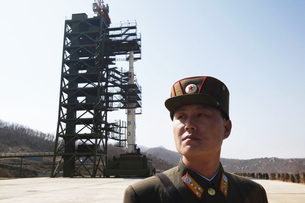 A soldier stands guard in front of a rocket sitting on a launch pad at the West Sea Satellite Launch Site in the northwest of Pyongyang in this April 8, 2012 file photo. Photo: Reuters