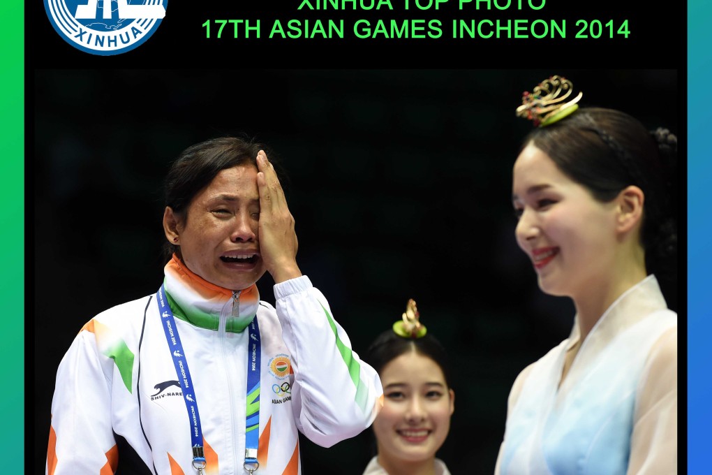 India's Sarita Devi in tears at the medal ceremony. Photo: Xinhua