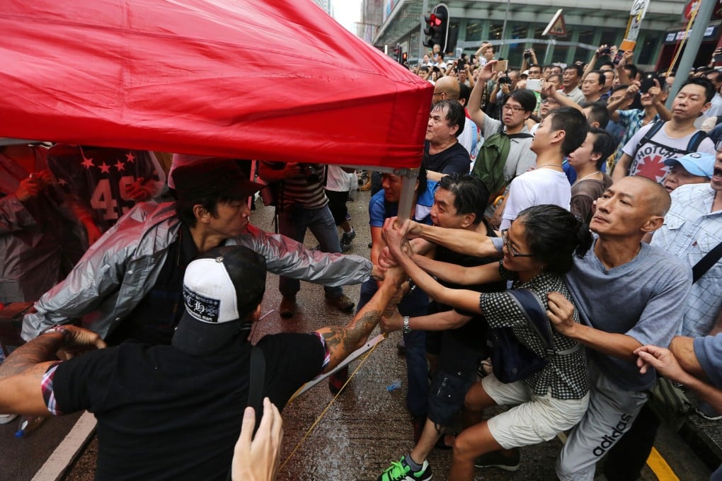 Anti-Occupy activists and Occupy Central protesters clash at the Mong Kok protest site yesterday. Protesters say there were not enough police on hand. Photo: Sam Tsang