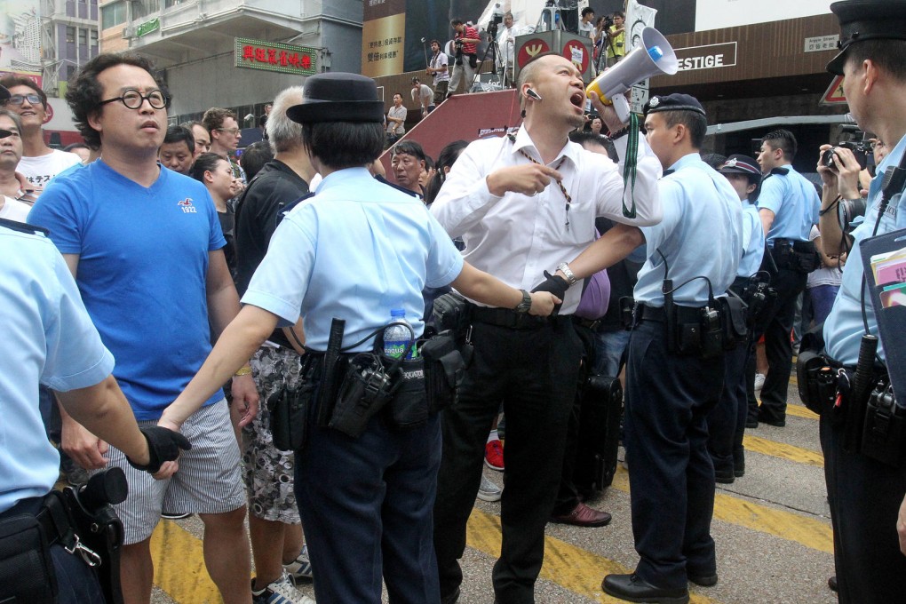 A Mong Kok shop owner addresses Occupy Central protesters on Nathan Road. Protesters there came under attack from opponents of Occupy Central. Photo: May Tse