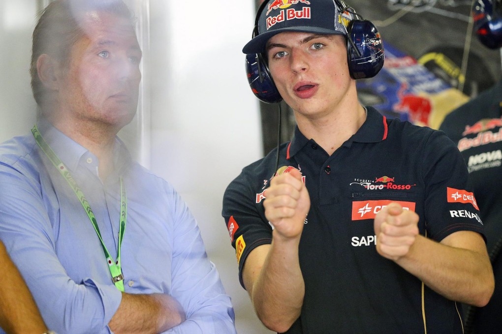Dutch Formula One driver Max Verstappen (right) of Scuderia Toro Rosso chats with his father Jos Verstappen, a former Formula One driver, at the team garage. Photo: EPA