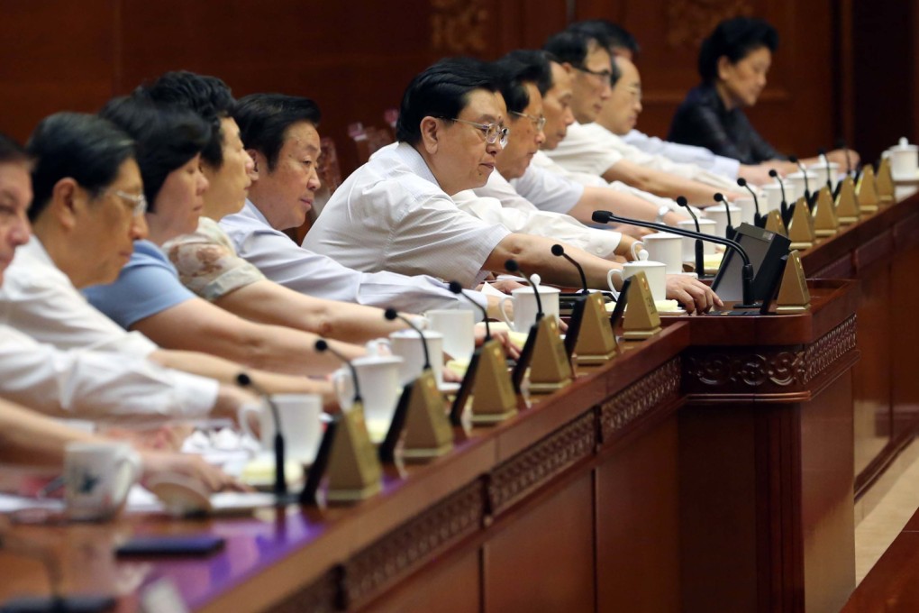 NPC Standing Committee members vote on August 31, when they unanimously approved a strict framework for the Hong Kong 2017 chief executive election. Photo: Xinhua