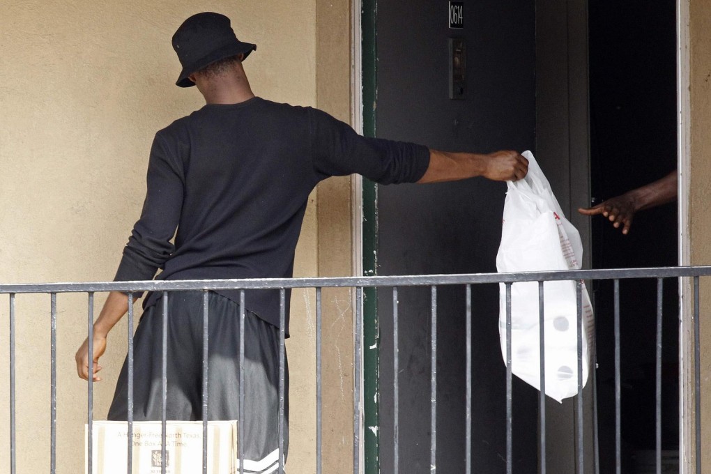Supplies are passed to occupants of the Dallas apartment where a man with Ebola stayed. Photo: Reuters