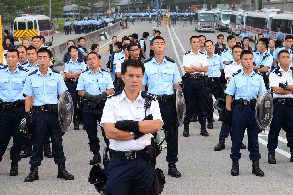 Police officers face pro-democracy protesters on Friday. Photo: AP