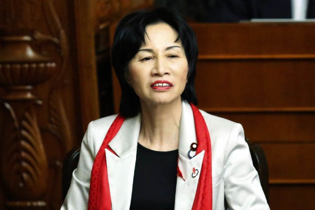 Justice Minister Midori Matsushima wears the offending red scarf, an "ordinary fashion item for an ordinary woman", she said. Photo: AFP