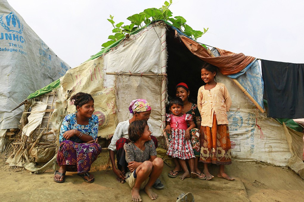 A family sits in front of their temporary shelter at a Rohingya refugee camp in Sittwe during Myanmar's  national census in April. Photo: Reuters