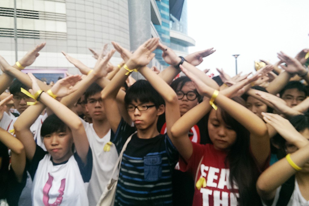 Hong Kong students protesting at the flag ceremony in Golden Bauhinia Square. Photo: Chris Lau