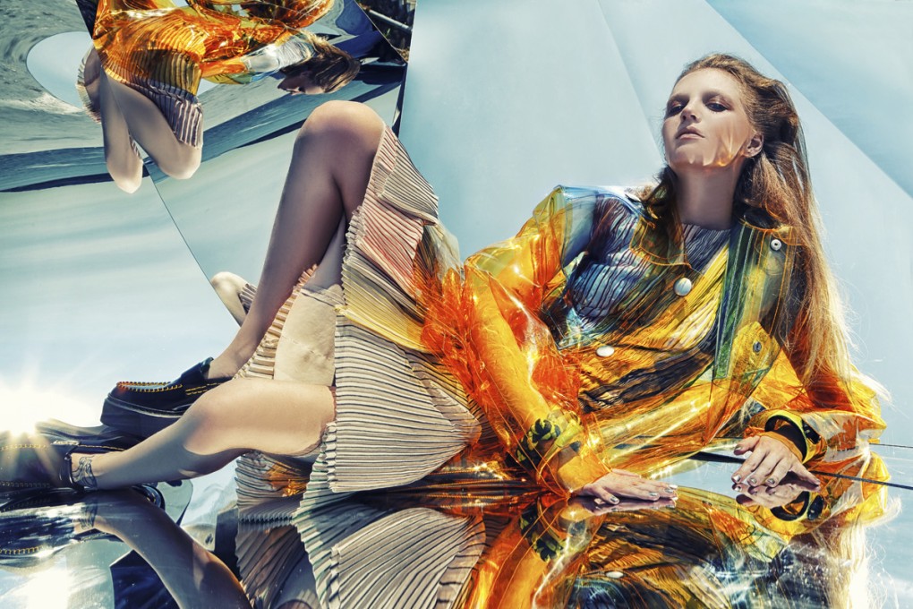 Pleated dress (HK$78,000) by Bottega Veneta. Transparent PVC coat (HK$16,250) by Miu Miu. On right hand: flannel, satin and resin braided bracelet (HK$11,000) and metal and lime green resin bangle (also HK$11,000) by Giorgio Armani. On left hand: lime green and black resin bangle (HK$13,000) by Giorgio Armani. Platform leather loafers (HK$9,600) by Céline.