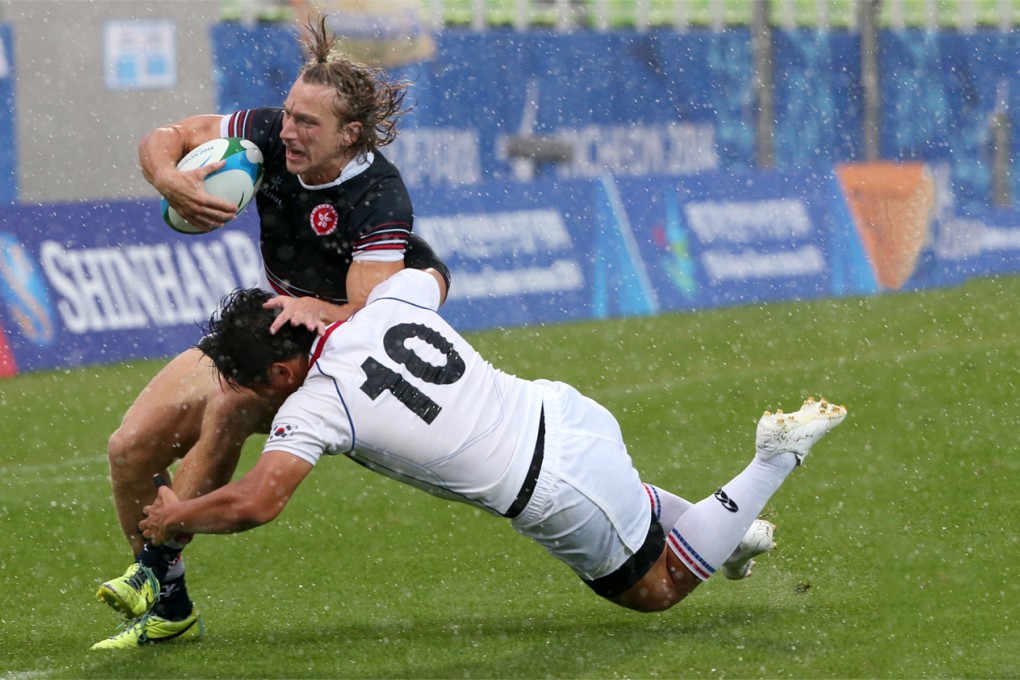 Tom McQueen is tackled by Kim Nam-uk of South Korea during Thursday’s Asian Games men’s semi-finals match at the Namdong Asiad Rugby Field in Incheon. Hong Kong won the semi 15-7, but lost the gold medal final against Japan 12-24. Photo: Nora Tam/SCMP