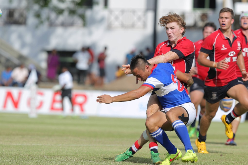 U20s skipper Hugo Stiles offloads under pressure against Taiwan during Hong Kong’s opening Asian qualifying clash in Colombo. Photo: Dennis Muthuthantri for HKRFU