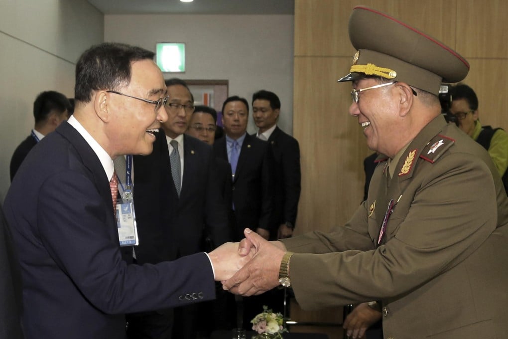 Vice-Marshal Hwang Pyong-so (right) greets the South Korean prime minister. Photo: AP