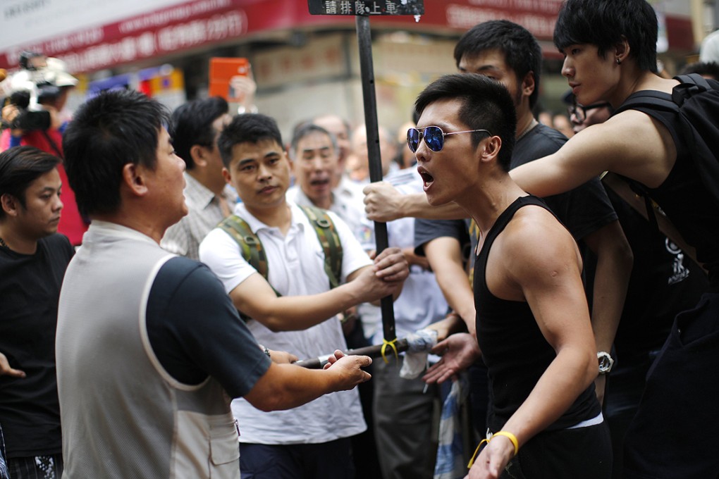 A pro-democracy protester argues with an anti-Occupy Central activist in Mong Kok on Saturday. Photo: Reuters