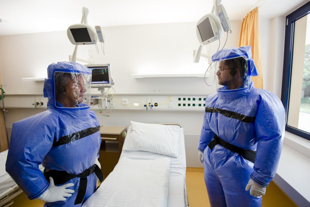 Ebola's lethality means protective suits are a must, but they make it harder to judge if a vaccine works. Photo: Reuters