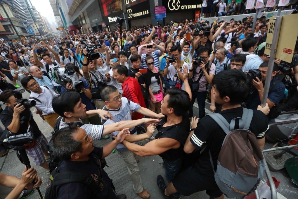 Occupy and anti-occupy groups scuffle in Mong Kok on Saturday. Photo: Sam Tsang