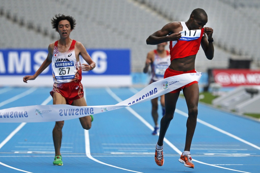 Bahrain's Ali Hasan Mahboob wins the men's marathon in front of a near empty stadium in Incheon. Photo: Reuters