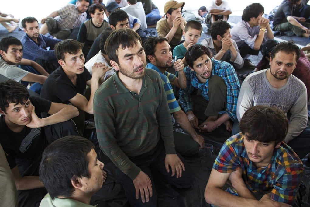 Suspected Uygurs from Xinjiang sit inside a temporary shelter after they were detained near the Thailand-Malaysia border in this file picture from March. Photo: Reuters