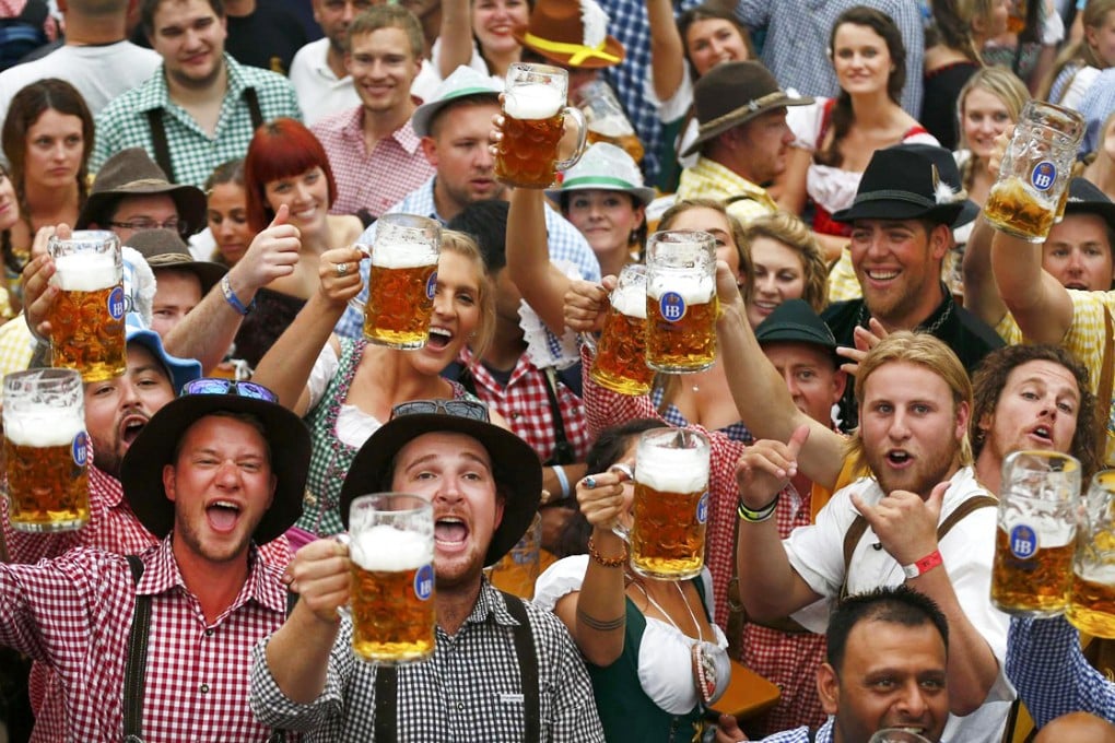 Oktoberfest revellers in Bavarian attire raise their one-litre mugs during the annual beer festival, which attracted millions of visitors from around the world. Photo: Reuters