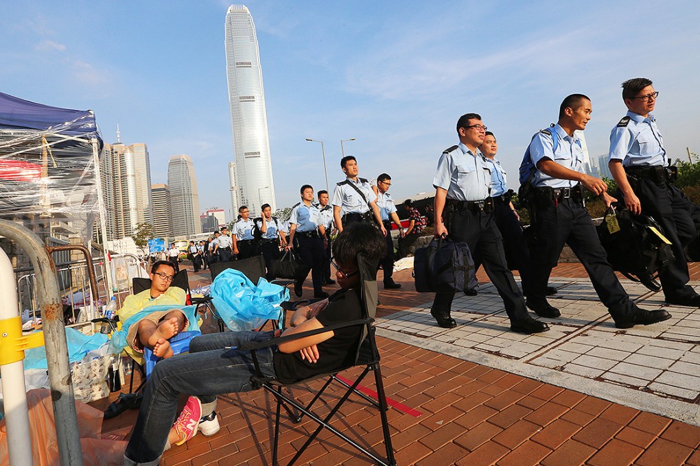 Police officers arrive at the chief executive's office in Admiralty as Occupy Central protesters camp out. Photo: David Wong